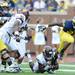 Michigan running back Fitzgerald Toussaint attempts to escape Central Michigan safety Avery Cunnighman as he runs the ball during the first half at Michigan Stadium on Saturday, August 31, 2013. Melanie Maxwell | AnnArbor.com